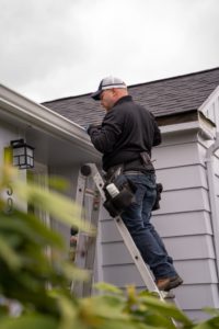 Technician installing Gutters