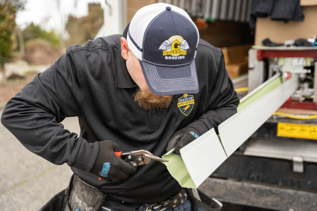 Technician getting new gutters ready for installation