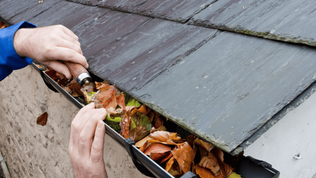 Hand-cleaning Gutter Debris